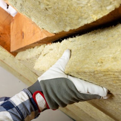 Man,Installing,Thermal,Roof,Insulation,Layer,-,Using,Mineral,Wool